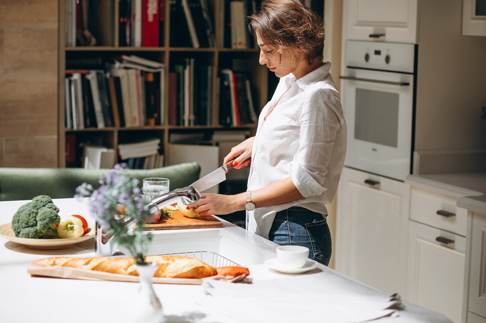 Woman cooking at kitchen in the morning Woman cooking at kitchen in the morning